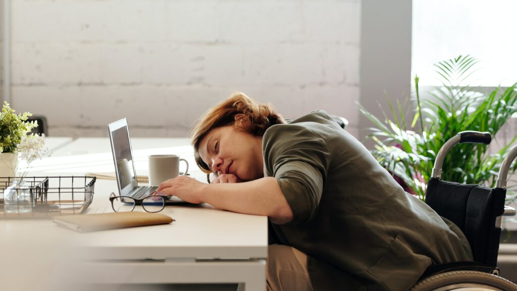 Woman sleeping at desk with laptop