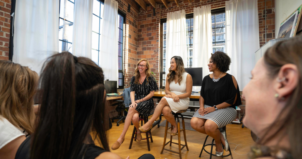 women sitting on chairs inside a room