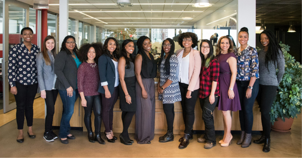 group of women standing near desk